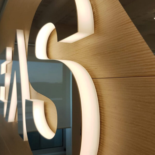 Logo su parete in acciaio mirror e plexiglas opalino - TraSparente Group